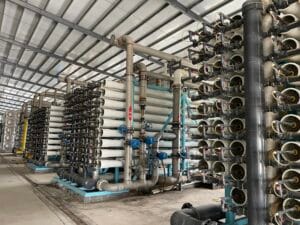 Multiple rows of industrial reverse osmosis (RO) membrane vessels in a large water treatment plant