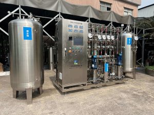 Modern stainless steel desalination equipment featuring a control panel and piping system.