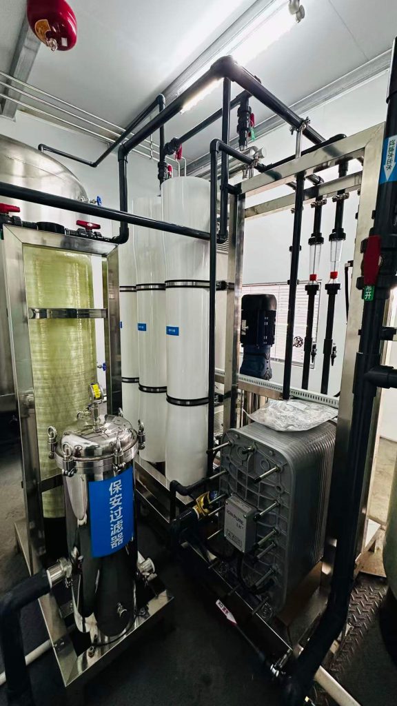 Close-up view of Globaluf's ultrapure water system featuring Reverse Osmosis (RO) membrane housings, a stainless steel security filter, a visible ION PURE LX+ Electro-Deionization (EDI) module, and a mixed-bed ion exchange polisher, showcasing advanced multi-stage purification.