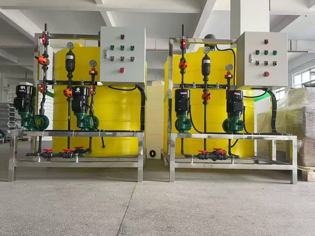Image of a chemical dosing system with two yellow tanks, pumps, and control panels used in industrial water treatment applications.