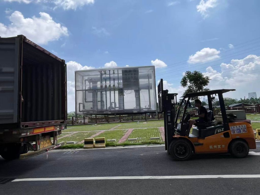 Heavy duty forklift loading protective film wrapped 4000 LPH skid mounted BWRO water treatment plant into 40ft HQ shipping container by Globaluf for Tanzania export